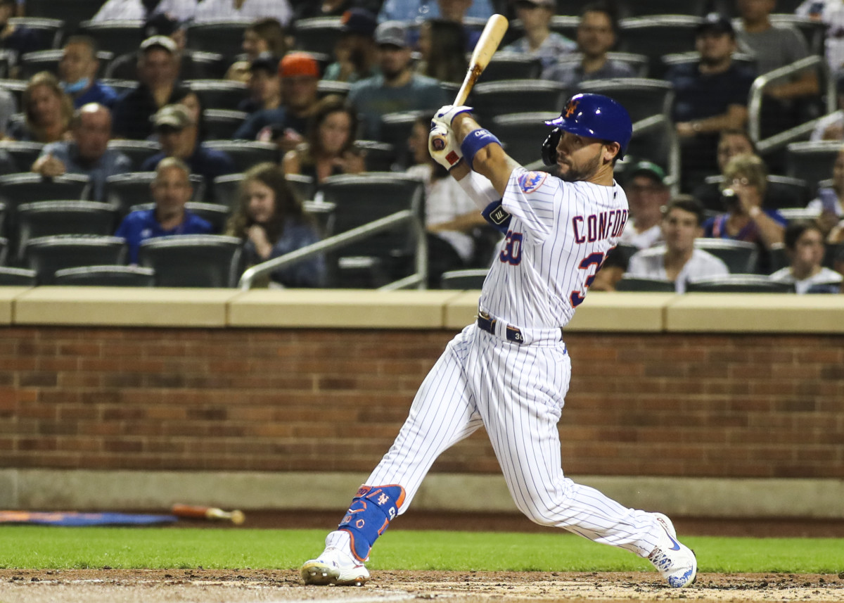 Sep 12, 2021; New York City, New York, USA; New York Mets right fielder Michael Conforto (30) hits an RBI single in the first inning against the New York Yankees at Citi Field.